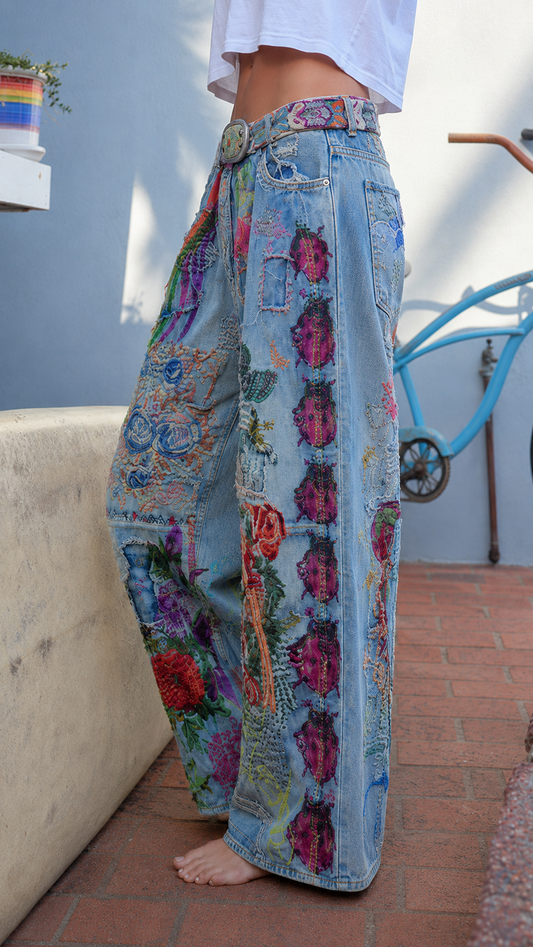 Side view of light blue floral patchwork wide leg jeans with high waist and full-length leg