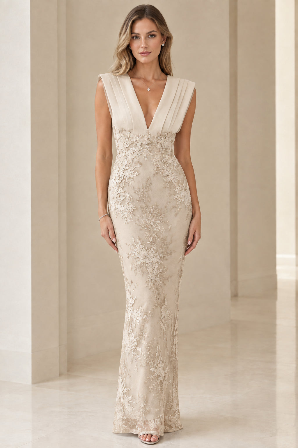 Model wearing champagne cream corded lace pleated V-neck maxi gown