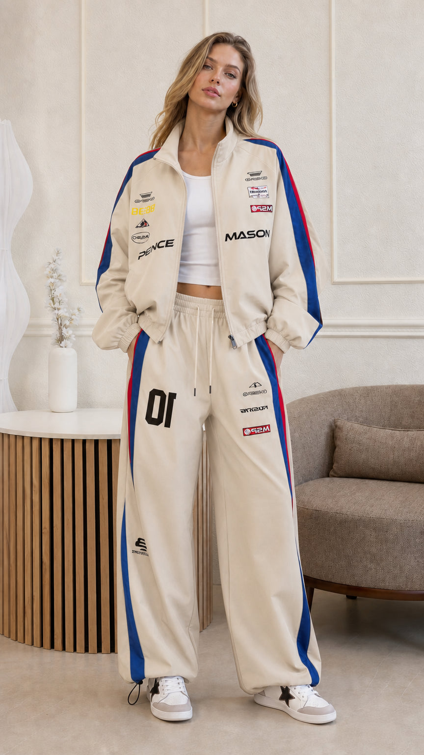 Full front view of woman wearing beige and blue stripe racing tracksuit set