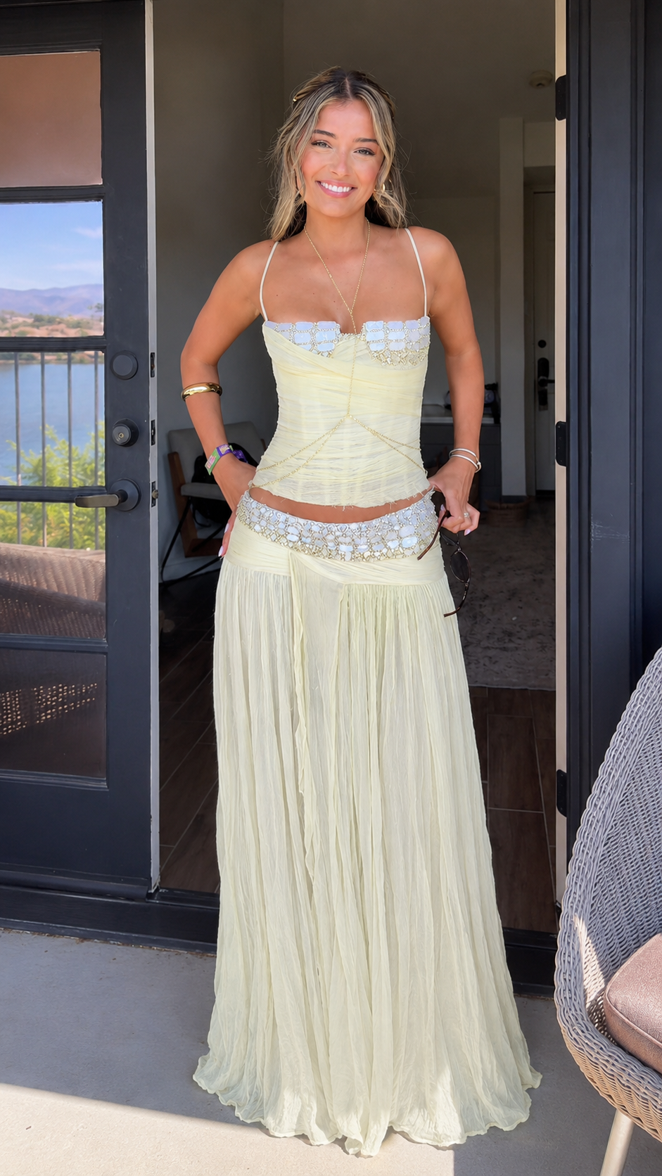 Front view of butter yellow lace trim corset top and pleated maxi skirt set