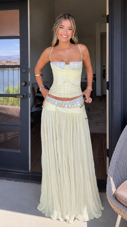 Front view of butter yellow lace trim corset top and pleated maxi skirt set
