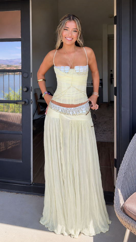 Front view of butter yellow lace trim corset top and pleated maxi skirt set