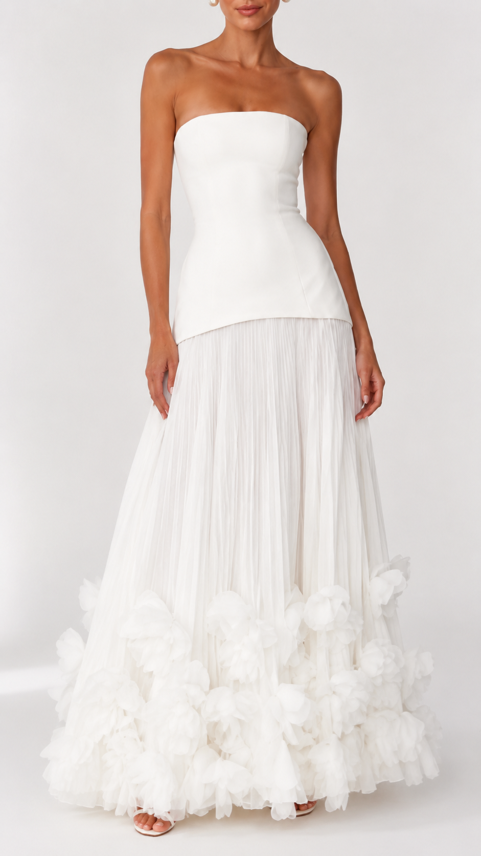 Front view of ivory strapless maxi dress with pleated skirt and floral hem