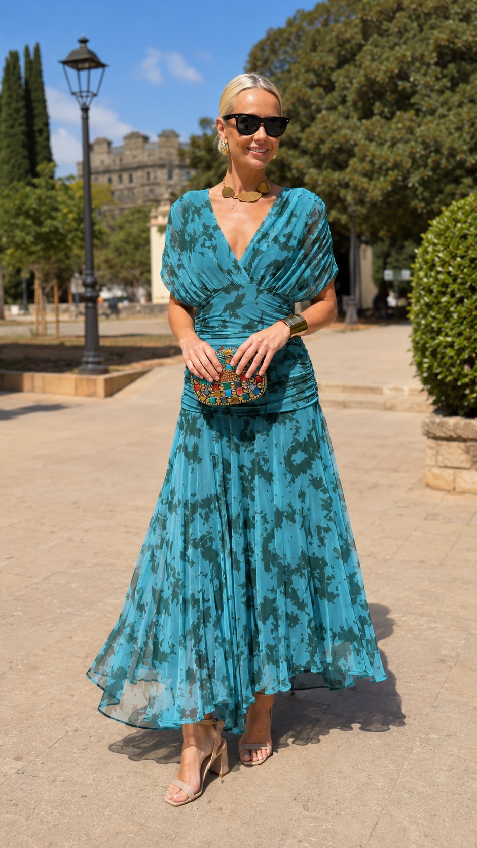 Front view of teal ruched V-neck pleated occasion dress with tonal print