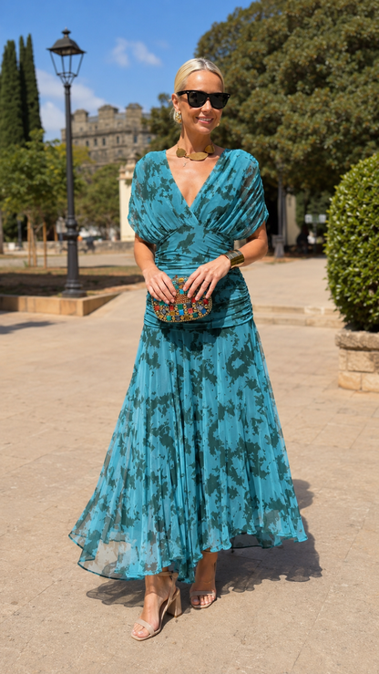 Front view of teal ruched V-neck pleated occasion dress with tonal print