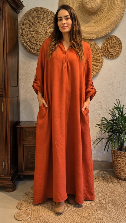 Front view of rust relaxed maxi kaftan dress with button-front neckline and side pockets