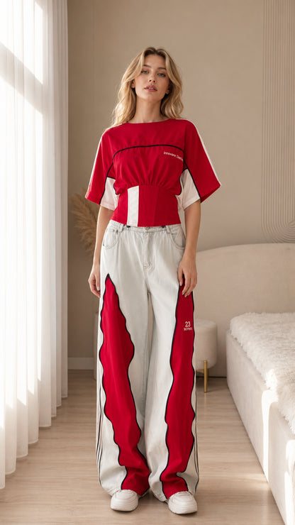 Front view of a red women's color block cropped sport top with contrast panels