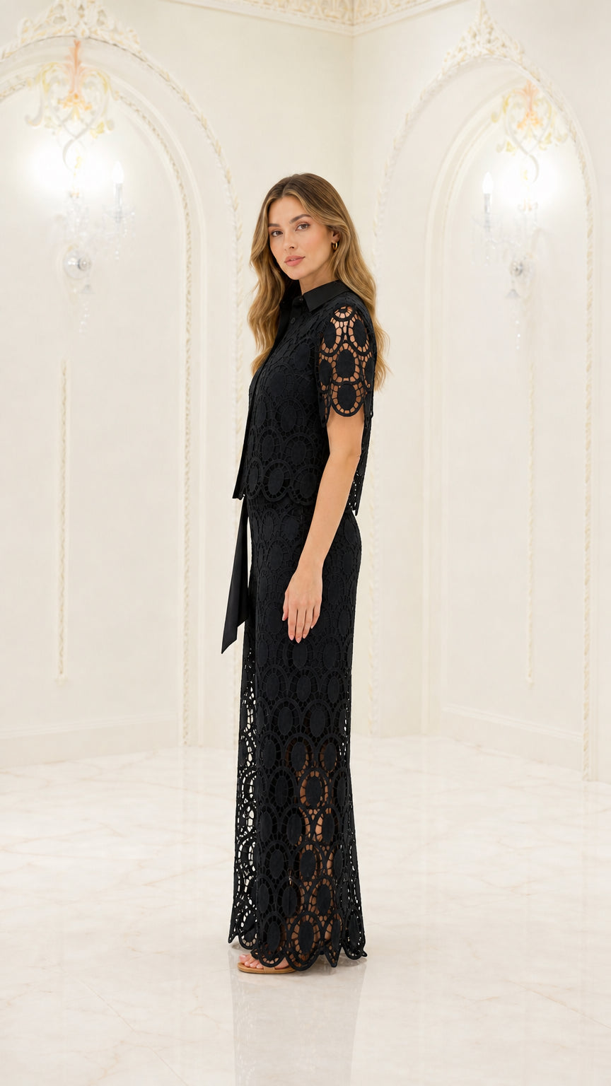 Side full-length view of woman modeling black lace two-piece pants set with waist sash