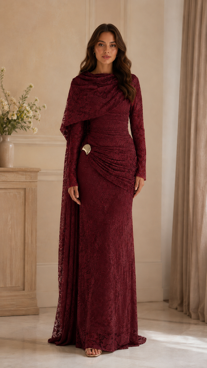 Front view of burgundy lace evening gown with ruched waist and asymmetrical draped neckline