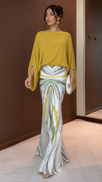 Mustard draped boat neck mermaid gown with flowing sleeves and printed skirt