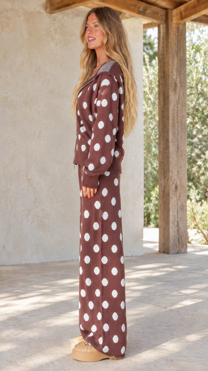 Side view of woman wearing brown polka dot knit two-piece lounge set