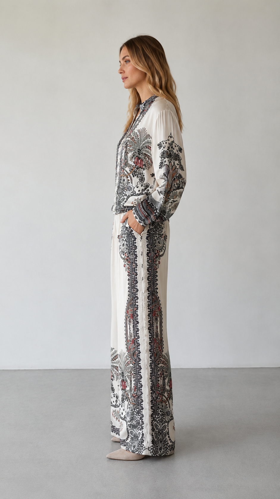 Side view of ivory printed two-piece set with long sleeves and flowing wide-leg pants