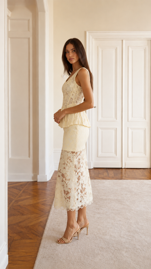 Side view of cream sleeveless lace peplum midi dress set with fitted bodice