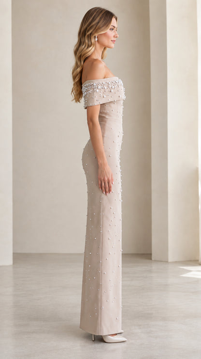 Side profile view of Champagne off-the-shoulder formal gown with pearl beading
