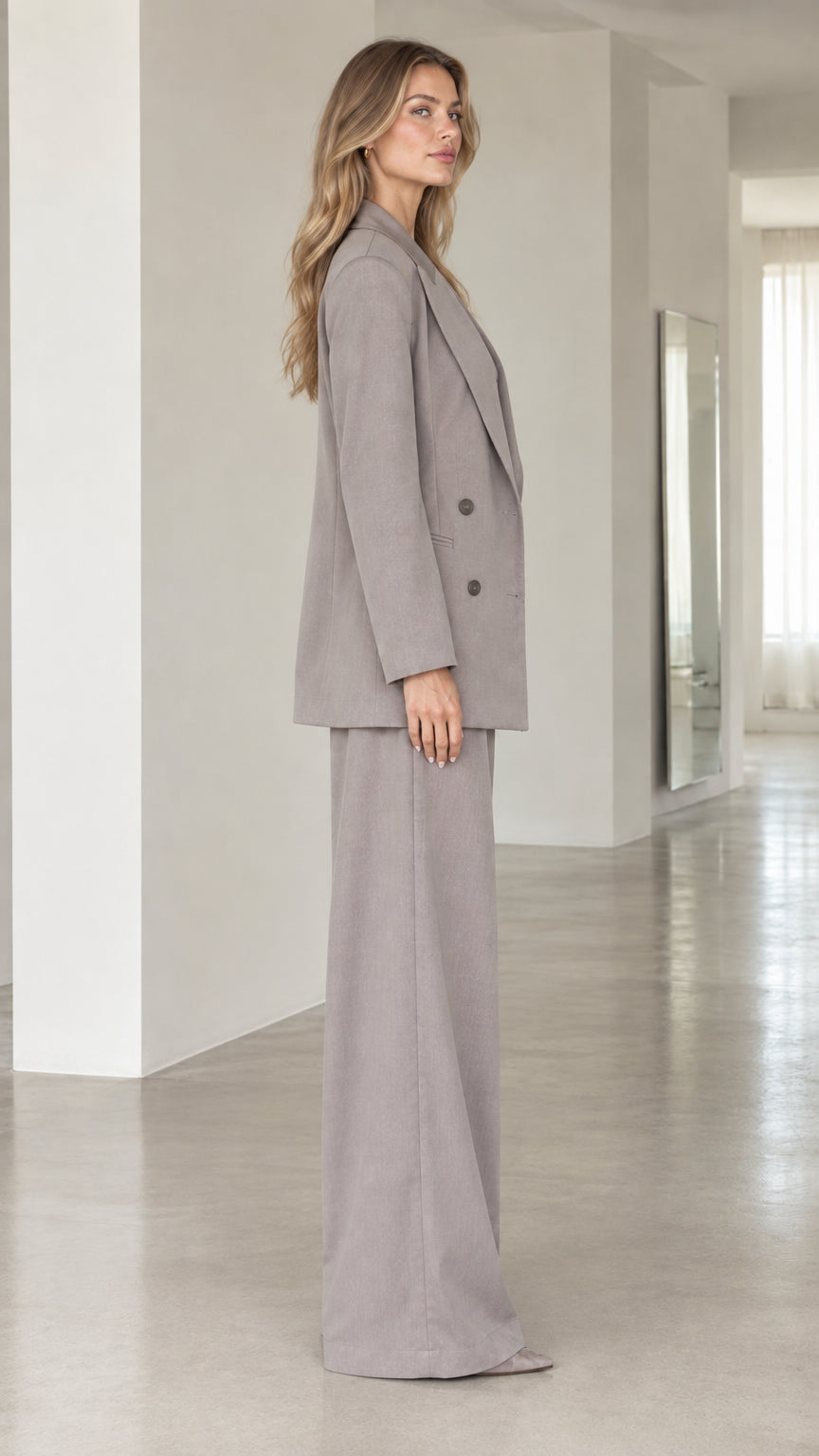 Side profile view of taupe grey 3-piece suit set showing relaxed tailored drape