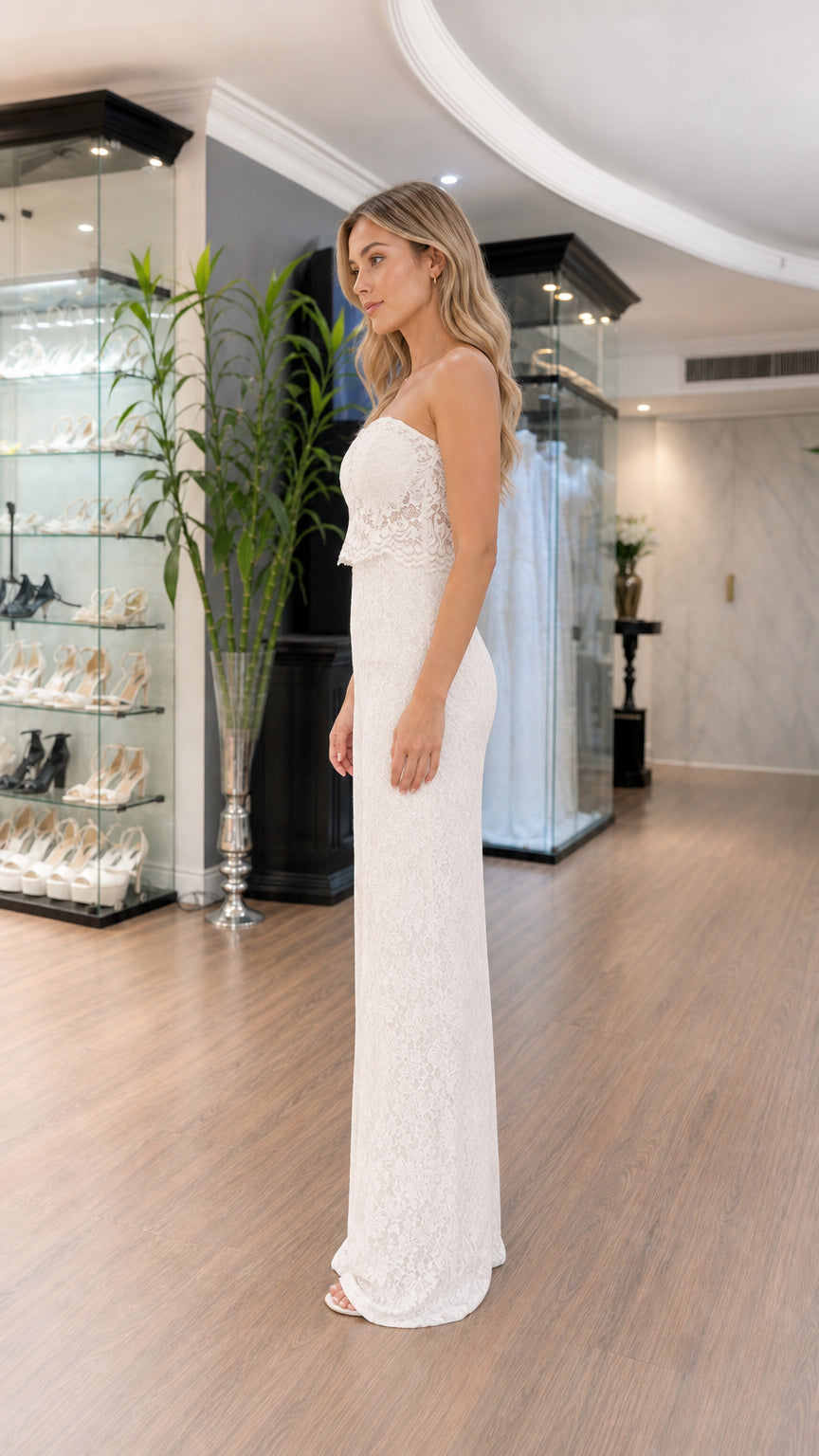 Side profile of woman wearing white strapless lace wide-leg jumpsuit