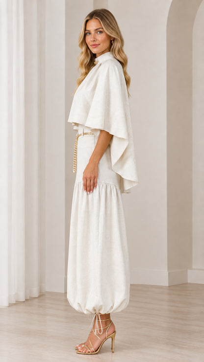 Side profile of ivory capelet top and ruched balloon trousers