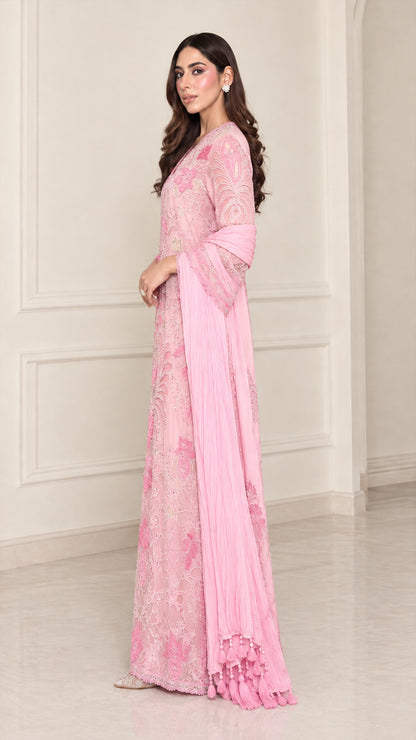 Side angle view of light pink embroidered formal evening gown