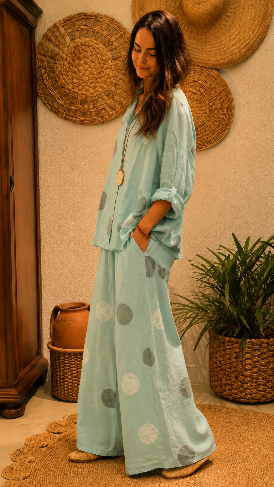 Side view of aqua polka dot matching set with rolled sleeves and flowy wide leg silhouette