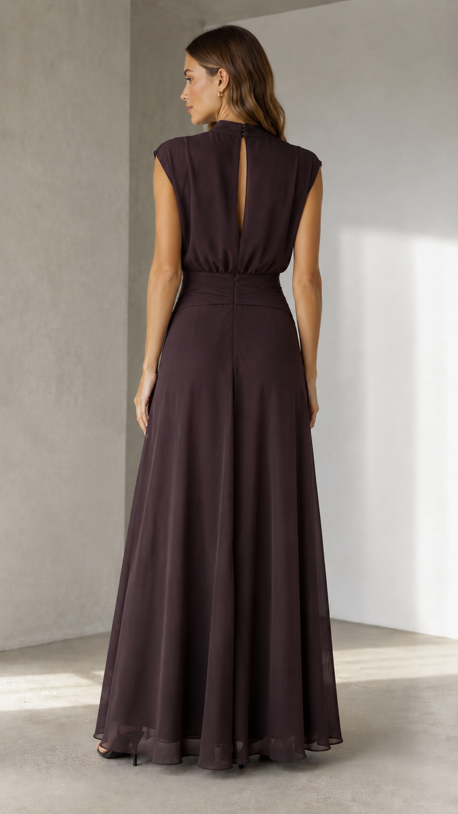 Back view of espresso brown maxi dress with keyhole back and full flowing hem