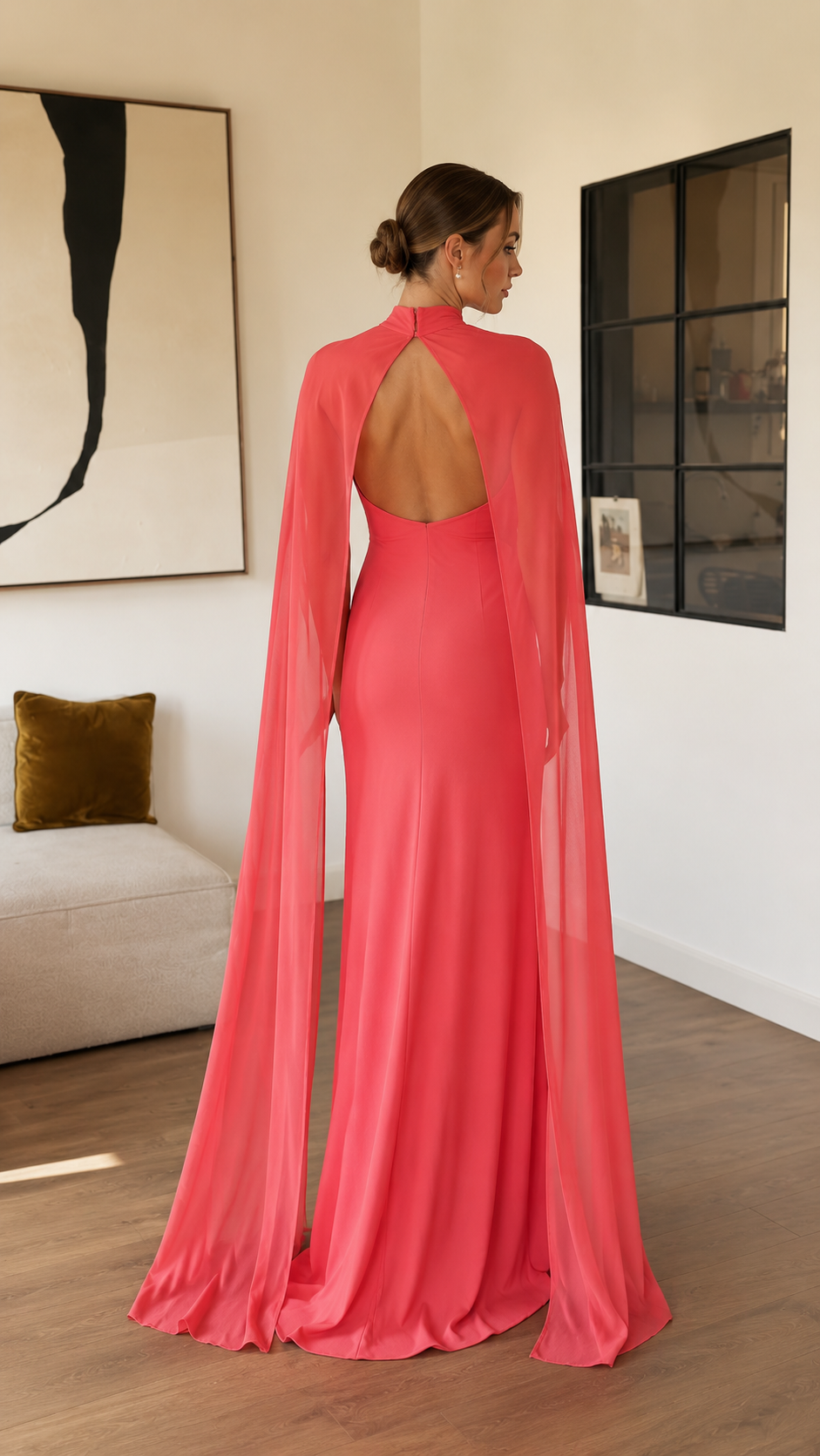 Back view of coral pink open back maxi dress with long cape panels