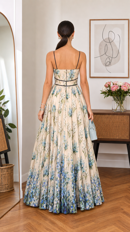 Back view of cream floral spaghetti strap maxi dress with slim straps and sweeping skirt