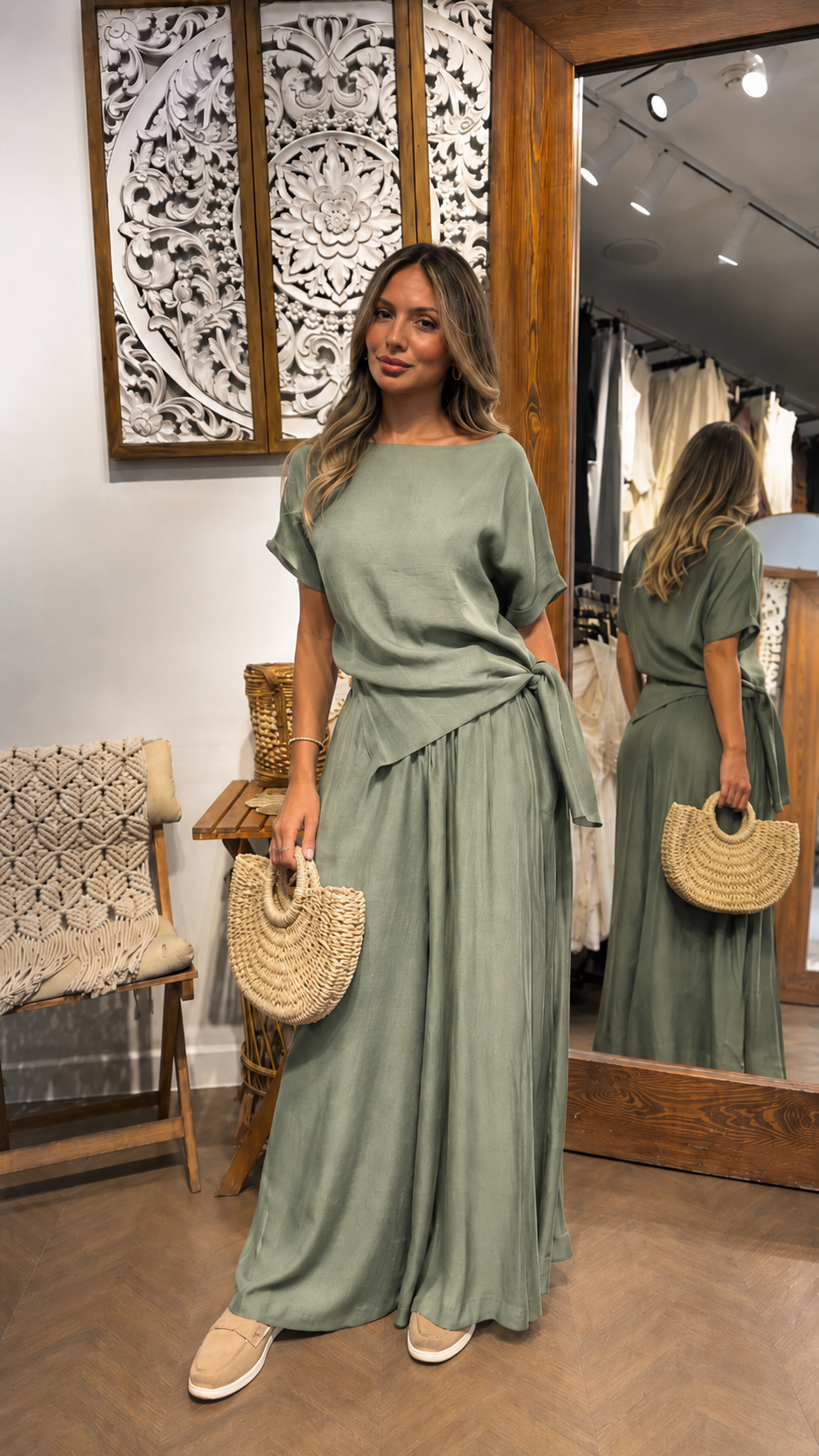 Woman wearing a sage green draped waist maxi dress with short sleeves and full-length skirt
