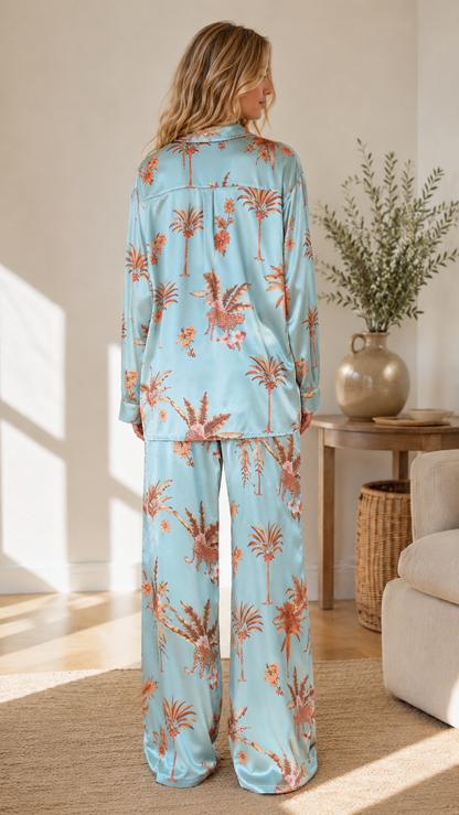 Back view of sky blue tropical print pajama set showing relaxed fit and wide-leg silhouette