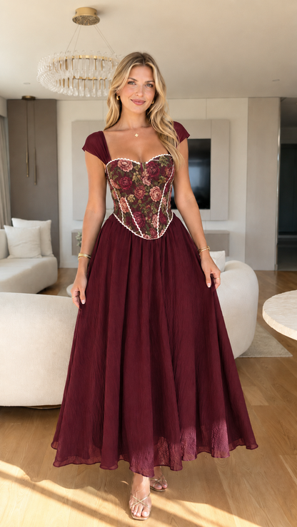 Front view of burgundy floral corset bodice maxi dress with cap sleeves