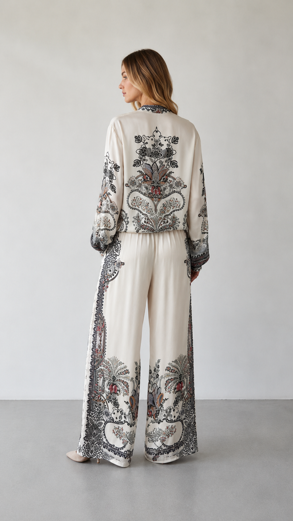 Back view of ivory paisley print matching set showing full back motif and wide-leg silhouette