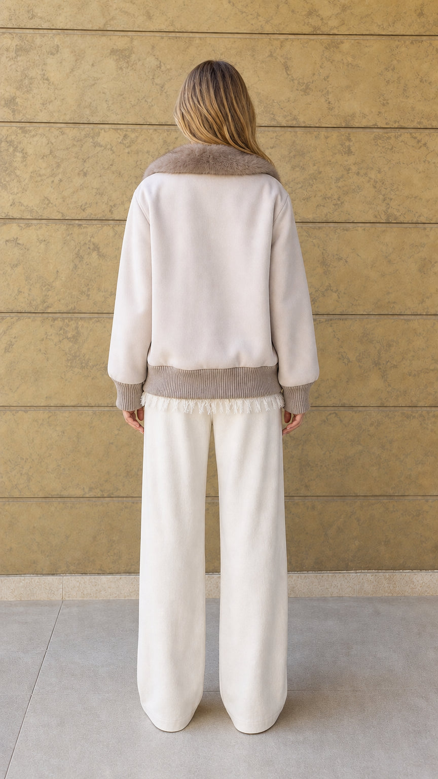 Back view of cream relaxed fit jacket with ribbed hem