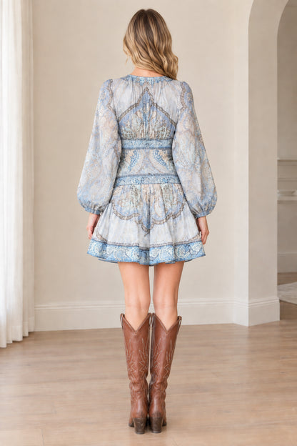 Back view of woman wearing Light Blue long sleeve tiered ruffle mini dress