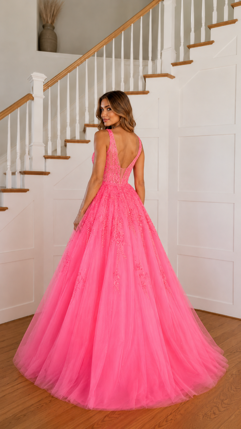Back view of hot pink ball gown with low open back and full floor-length skirt