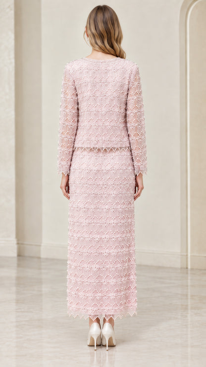 Back view of woman wearing blush pink beaded two-piece formal evening set