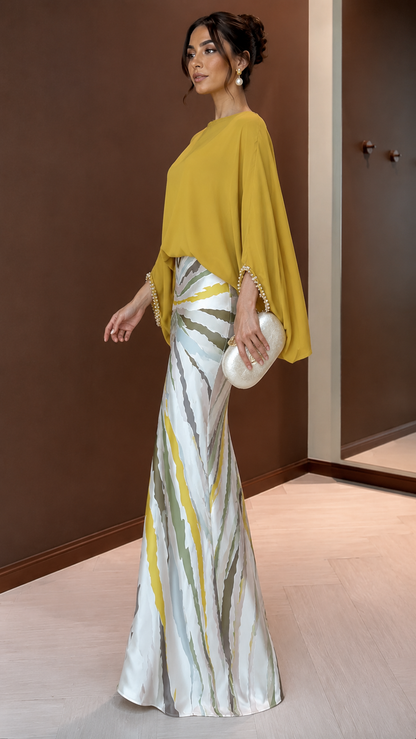 Side view of mustard cape sleeve maxi dress with flared mermaid hem