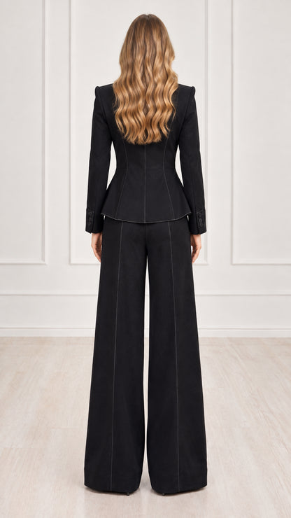 Back view of black tailored blazer and wide-leg pants set showing flattering fit