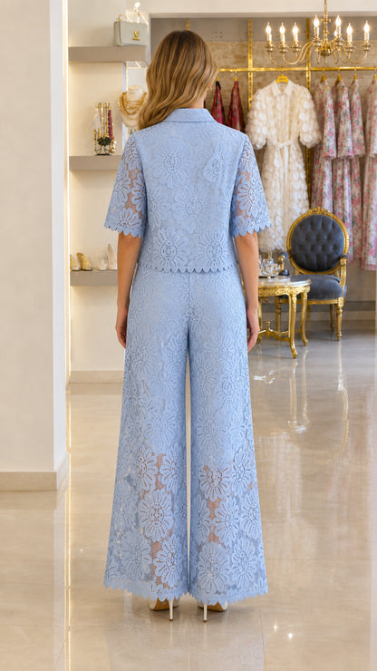 Back view of model in light blue floral lace short-sleeve top and wide-leg pants