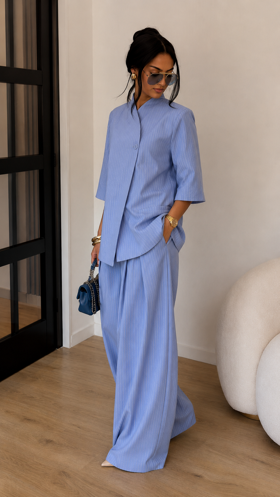 Angled front view of sky blue wide-leg pants set with asymmetric wrap-style top