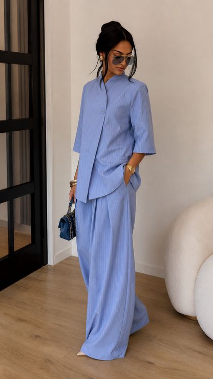 Angled front view of sky blue wide-leg pants set with asymmetric wrap-style top