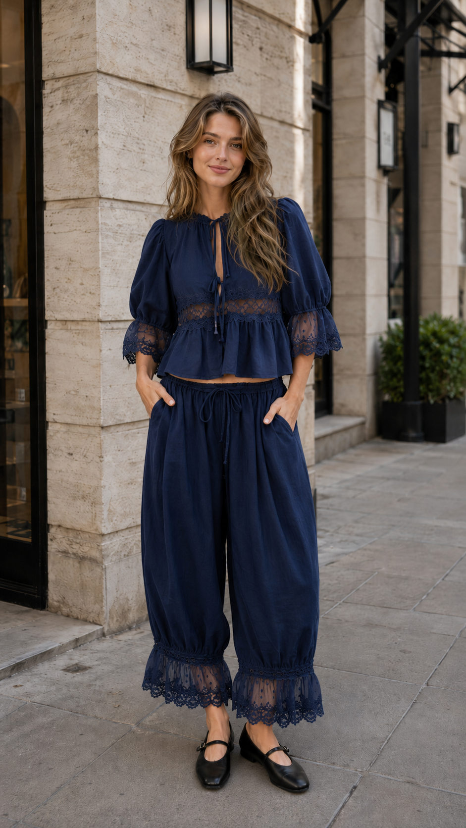 Navy blue tie neck blouse and lace hem pants set front view