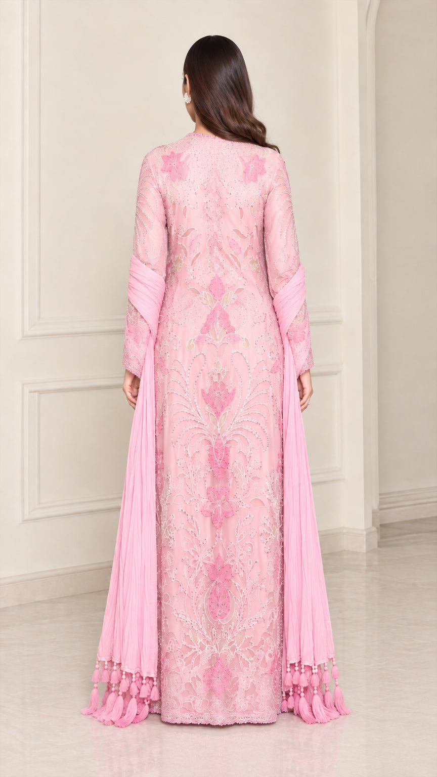 Back view of model wearing light pink embroidered maxi gown with long scarf