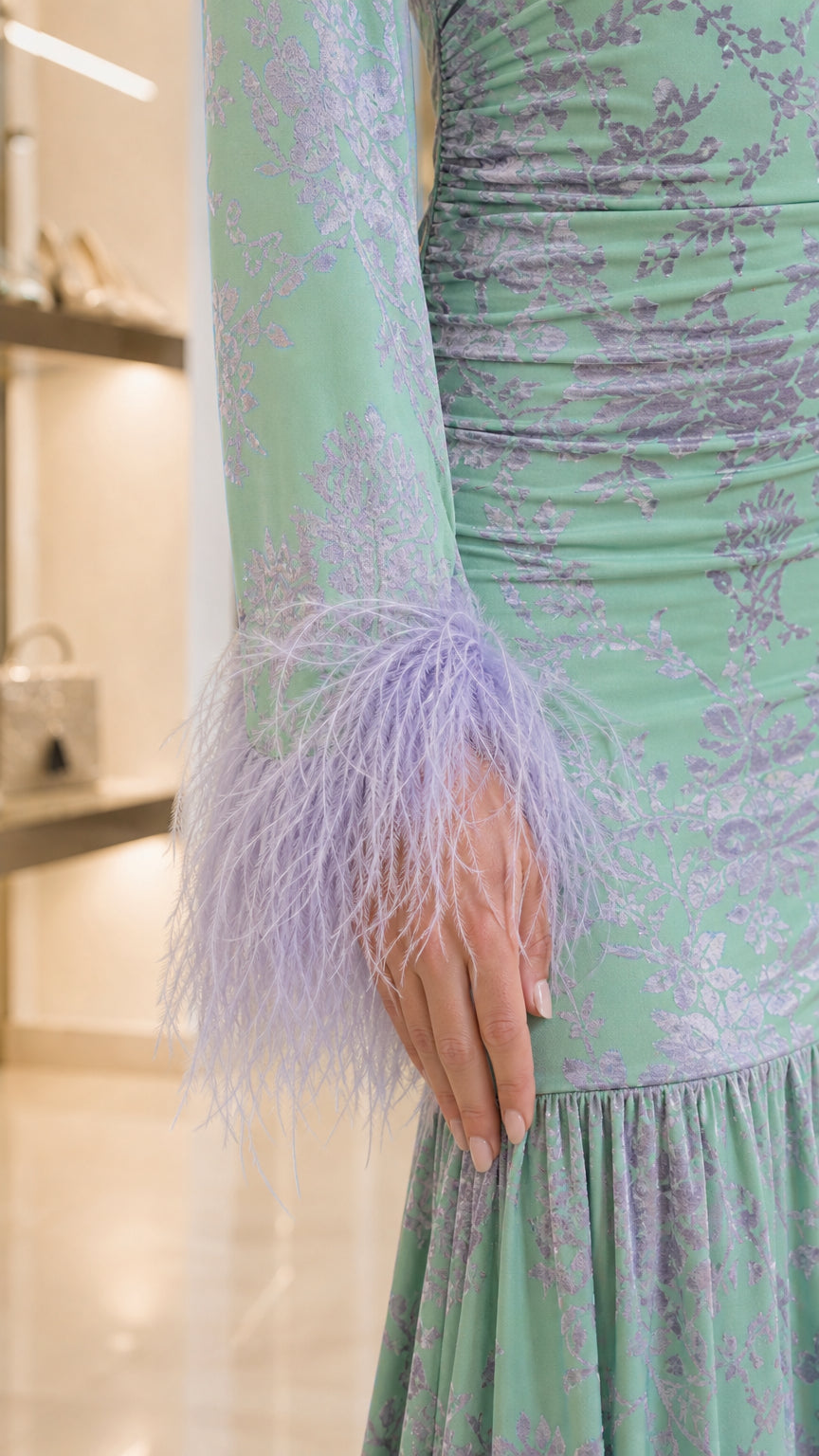 Close-up detail of lilac feather trim on the sleeve cuff and ruched floral jacquard fabric