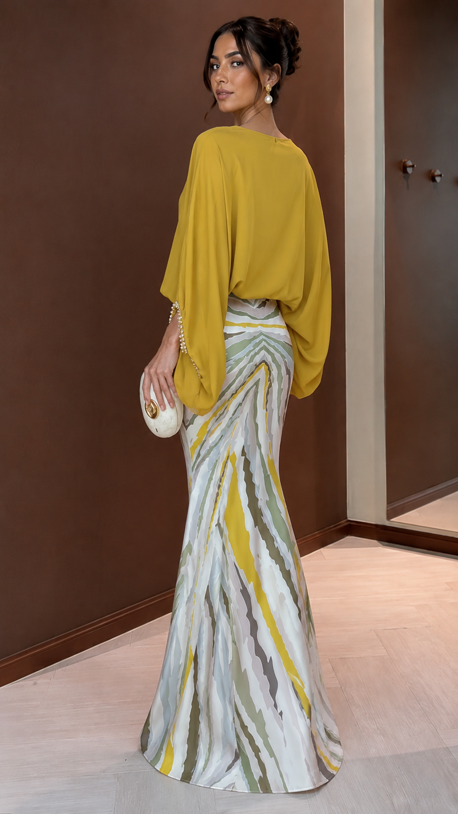 Back side view of mustard elegant maxi dress with draped top and printed skirt