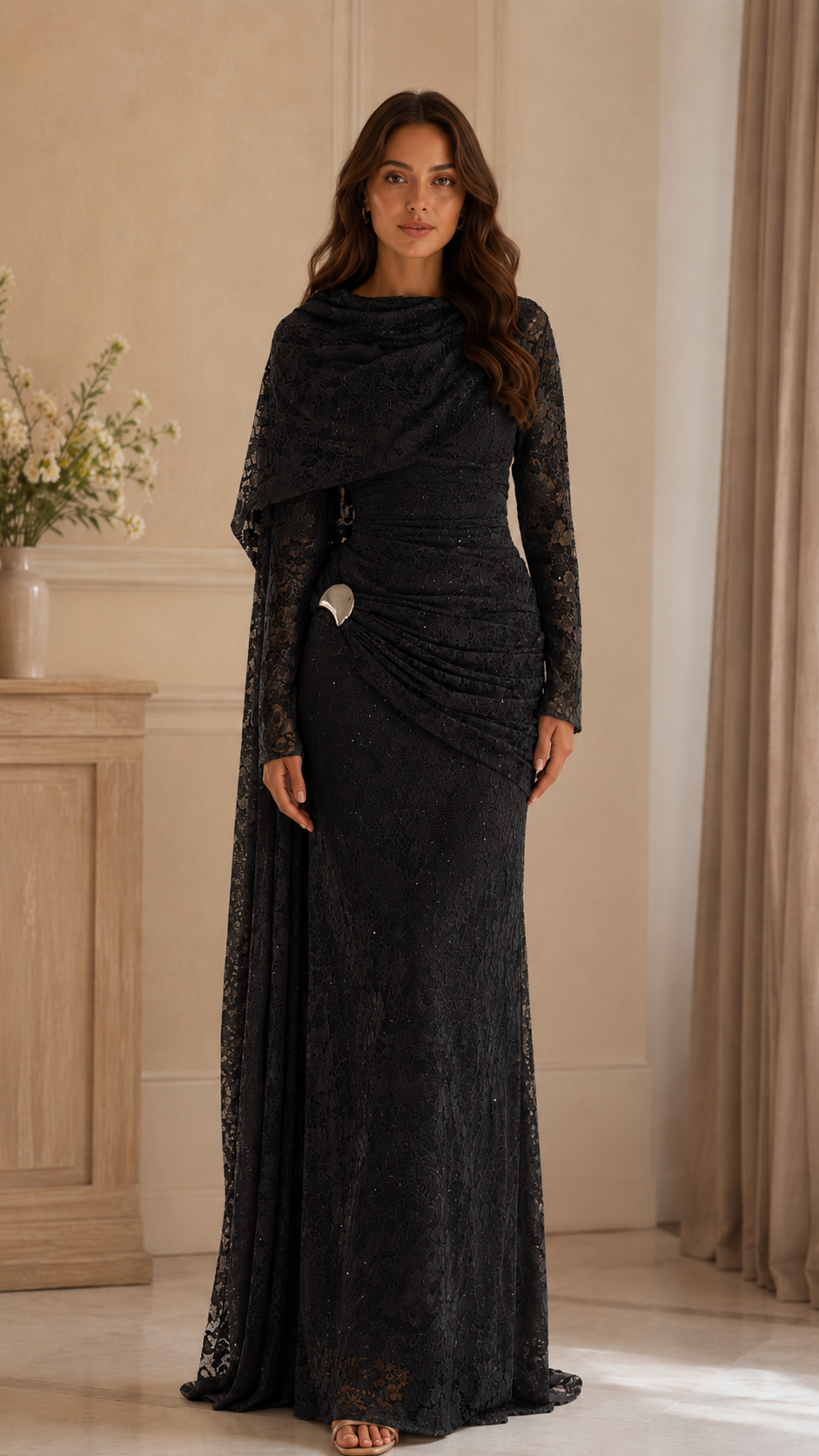 Front view of black lace maxi gown with gathered hip detail and decorative side accent