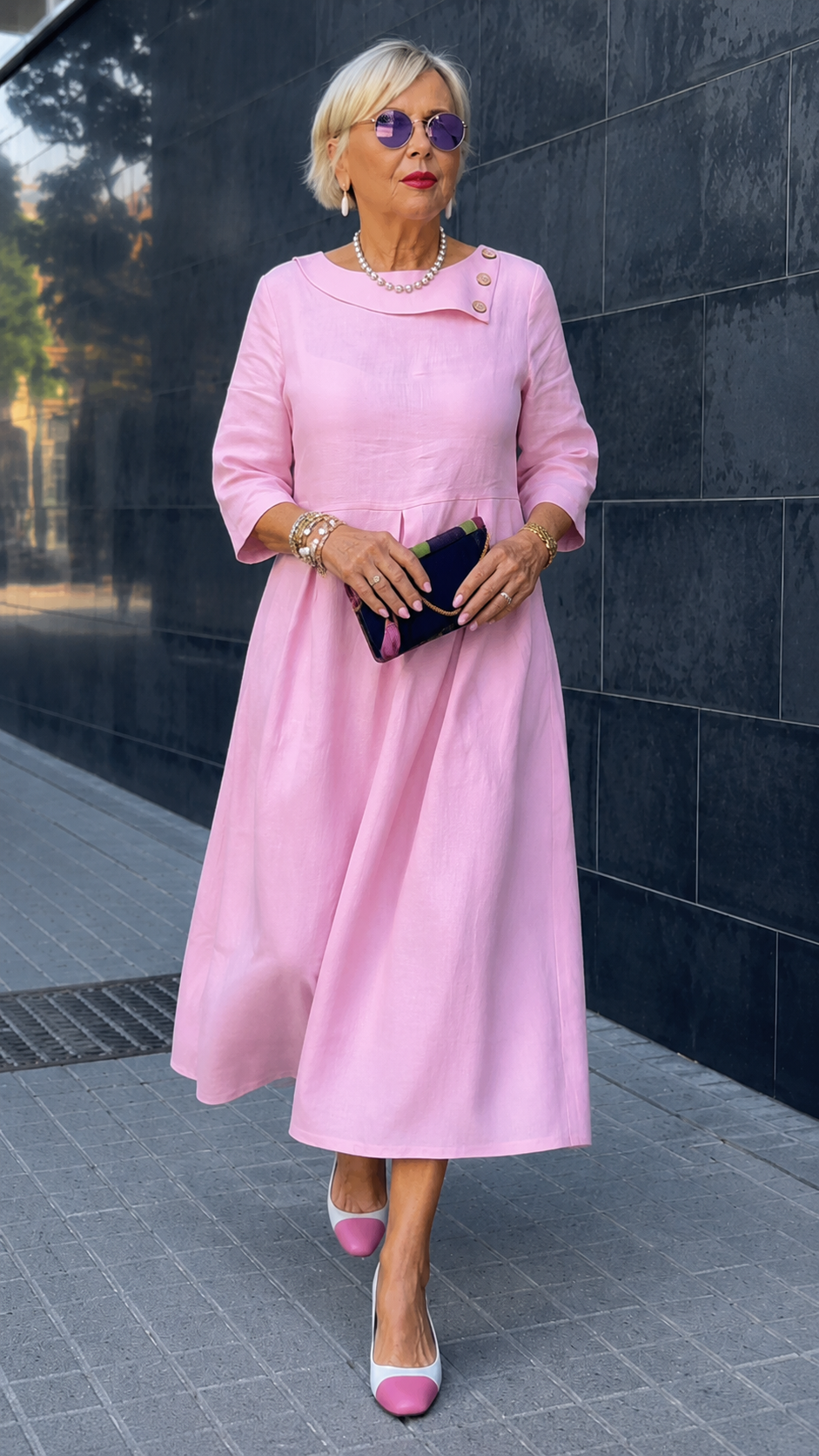 Front pose showing soft pink dress silhouette, pleated waist, and 3/4 sleeves