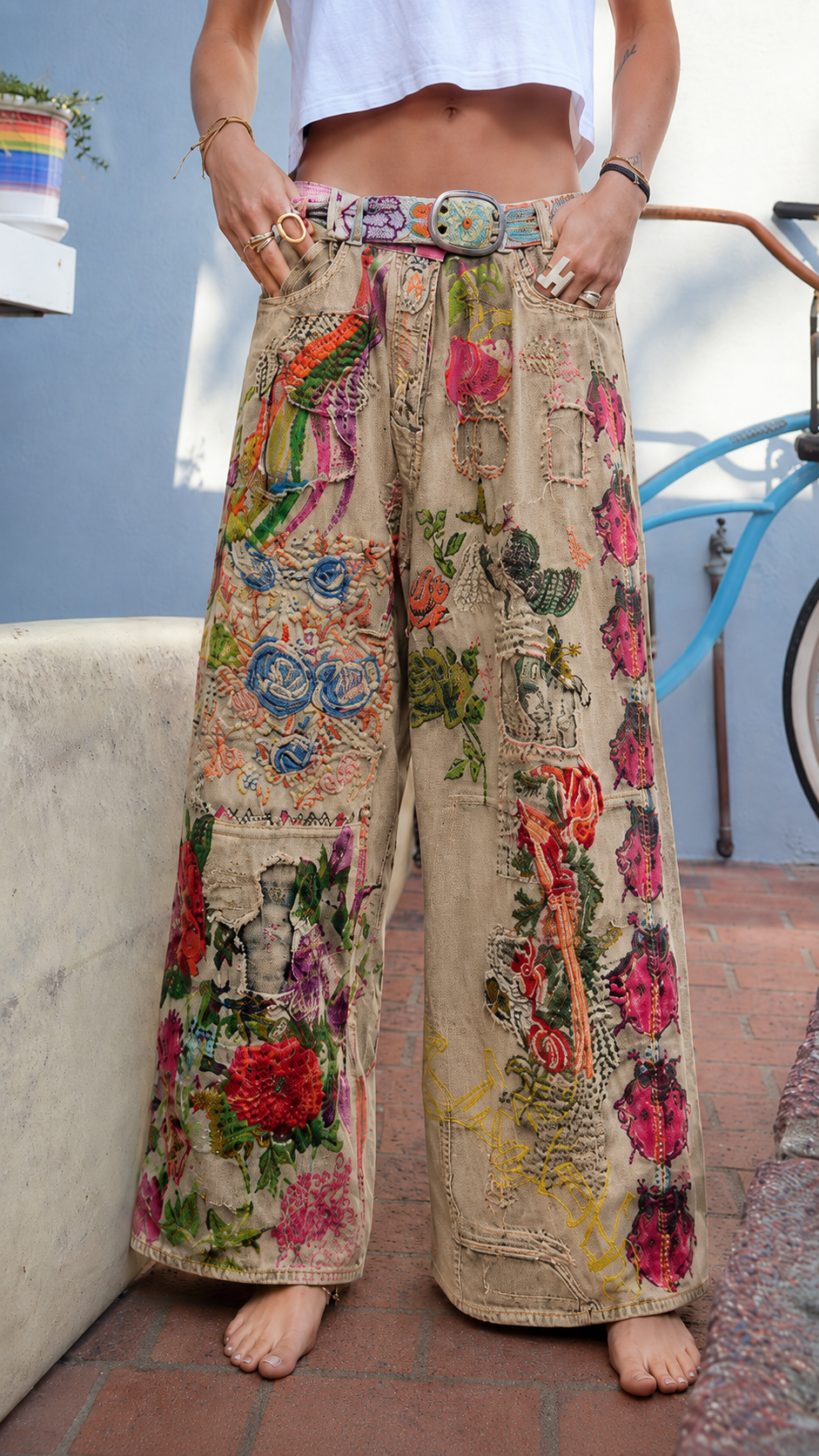 Front view of khaki wide leg jeans with multicolor floral patchwork and relaxed fit