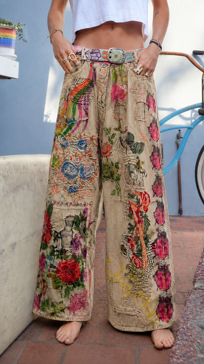 Front view of khaki wide leg jeans with multicolor floral patchwork and relaxed fit
