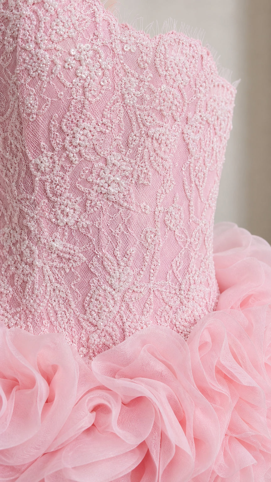 Close-up detail of pink embroidered lace sweetheart bodice and delicate organza ruffles