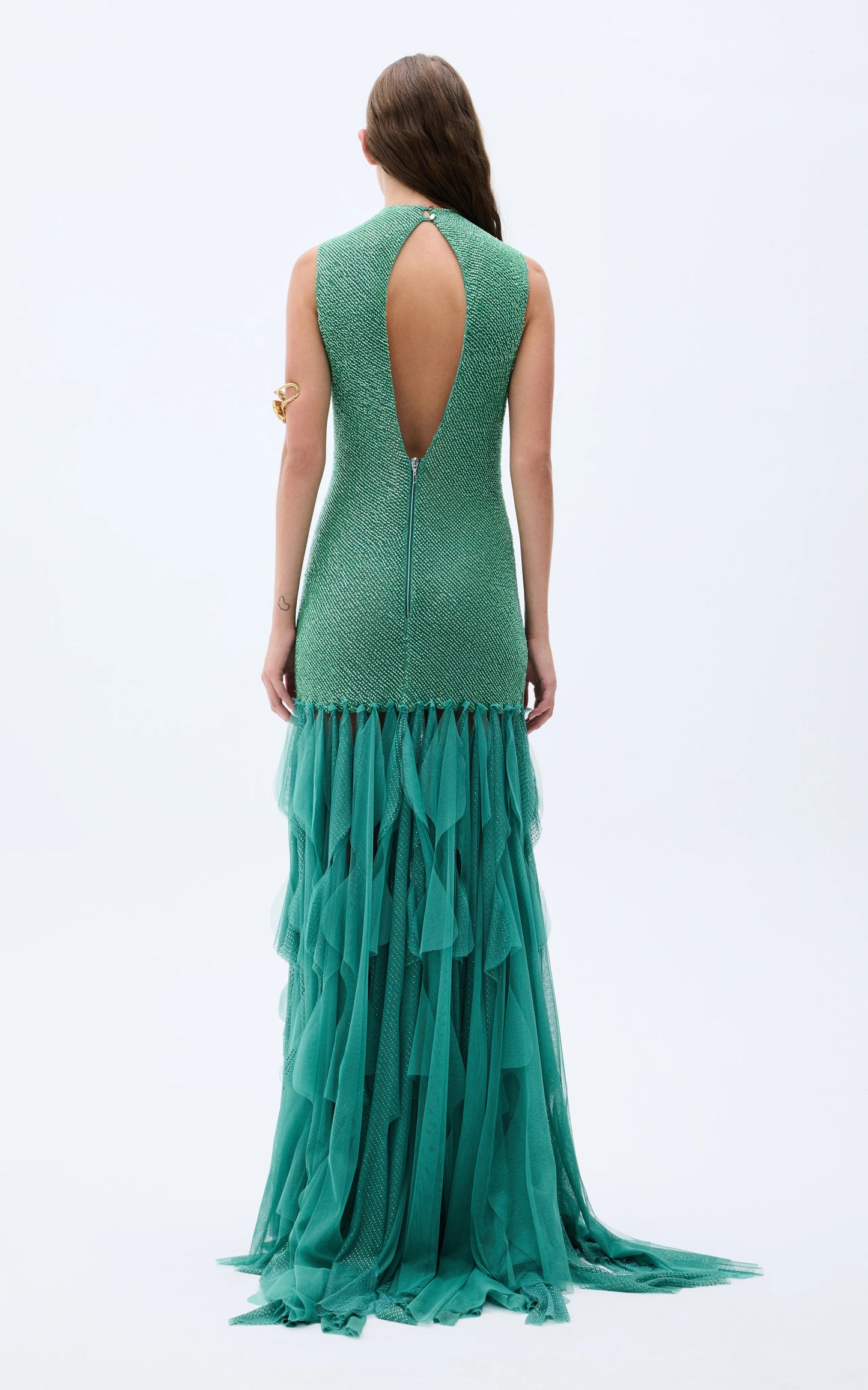 Back view of emerald evening gown with teardrop open back and layered floor-length hem