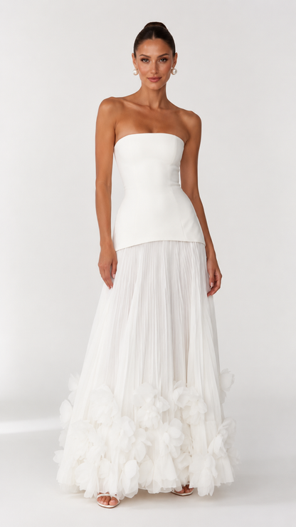 Front view of ivory strapless formal dress with textured floral hem detail